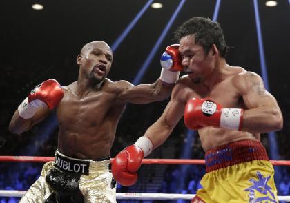 Floyd Mayweather hits Manny Pacquiao during their welterweight title fight on Saturday. (AP)