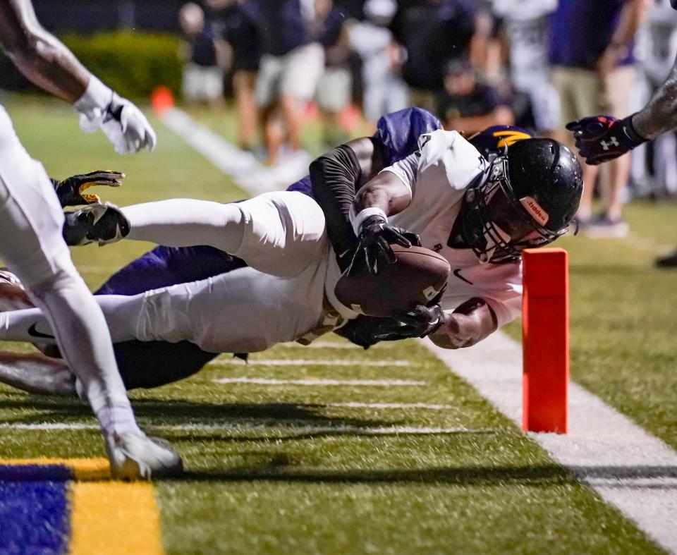 Golden Gate Titans running back John Lee Honorat (3) dives for the pylon and scores a touchdown during the fourth quarter of a district game against the Naples Golden Eagles at Staver Field in Naples on Thursday, Sept. 14, 2023.