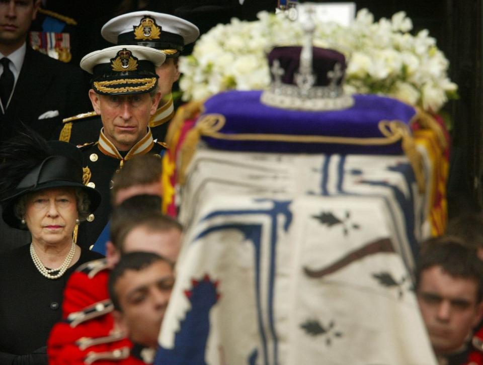 <p>The Queen and Prince Charles walk behind the Queen Mother’s coffin following her funeral at Westminster Abbey in central London. (PA Archive) </p>