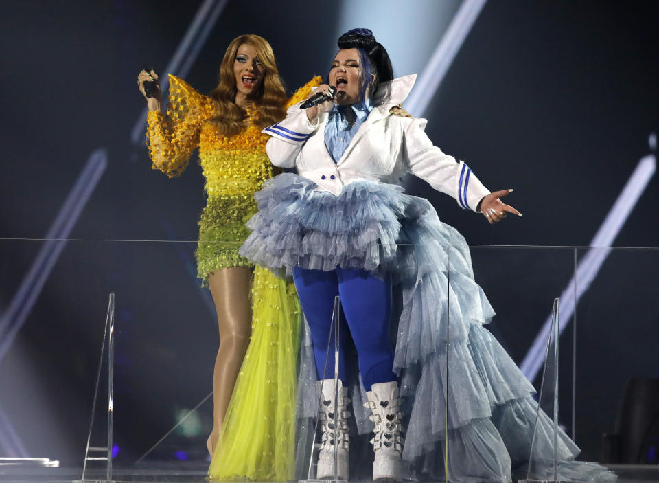 Israeli singer Dana International, left, the winner of the 1998 Eurovision Song Contest and Israeli Netta Barzilai, the winner of the 2018 Eurovision Song Contest perform during the 2019 Eurovision Song Contest grand final in Tel Aviv, Israel, Saturday, May 18, 2019. (AP Photo/Sebastian Scheiner)