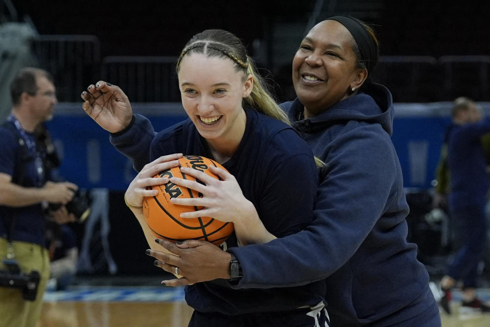 UConn's Paige Bueckers and assistant coach Tonya Cardoza laugh during a practice for an NCAA Women's Final Four semifinals basketball game Thursday, April 4, 2024, in Cleveland. (AP Photo/Carolyn Kaster)