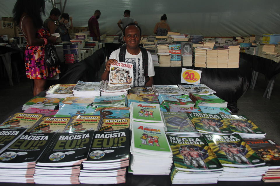 Mauricio&nbsp;Pestana at a book fair in Salvador. His books cover a range of topics, including black and indigenous Brazilian history, as well as stories about Afro-Brazilian orishas. (Photo: Aurora Ellis/ HuffPost)