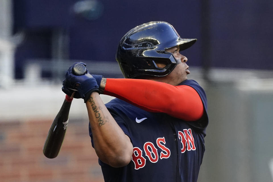 Boston Red Sox's Rafael Devers follows through one a three-run home run during the first inning of the team's baseball game against the Atlanta Braves on Tuesday, June 15, 2021, in Atlanta. (AP Photo/John Bazemore)