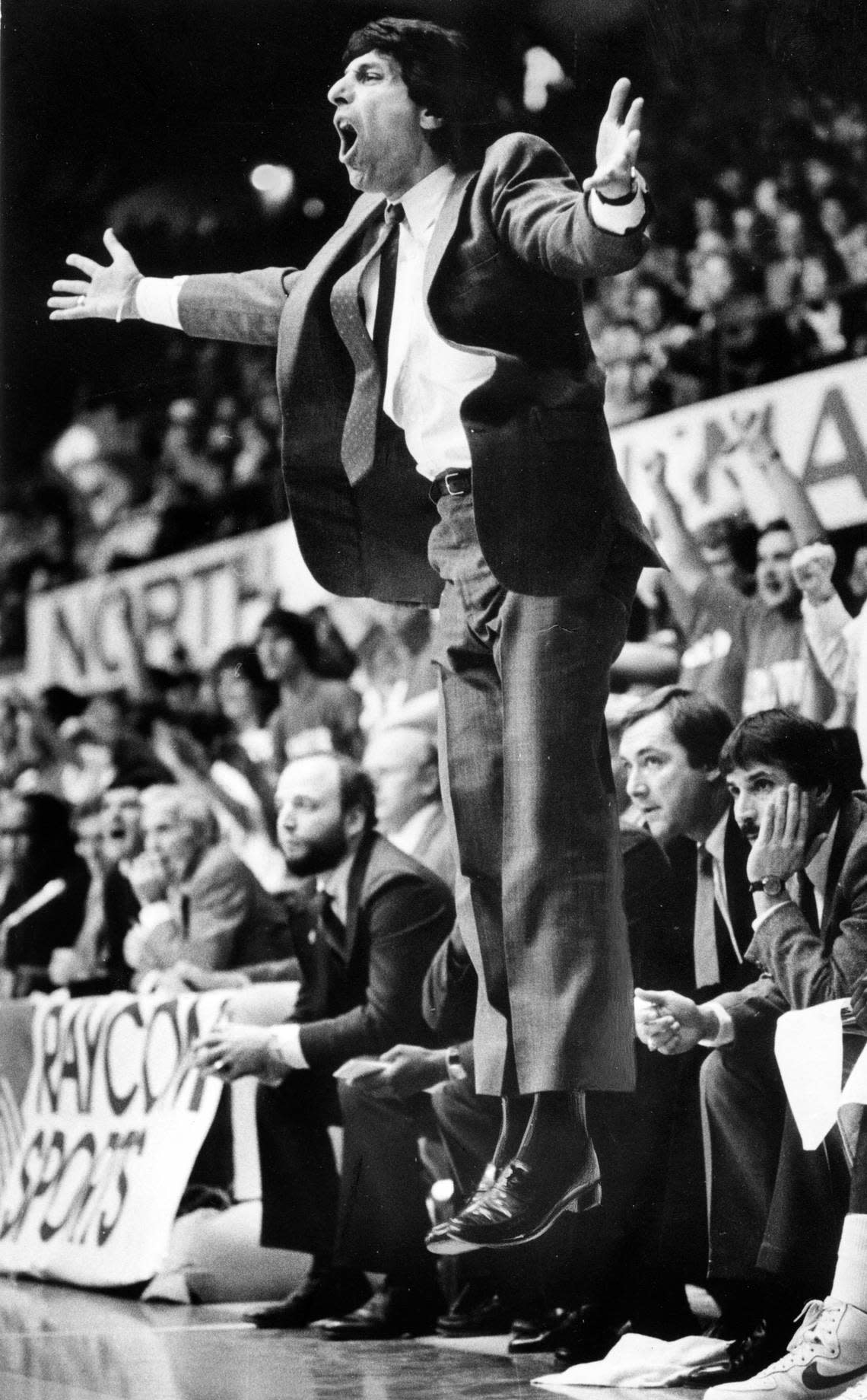 NC State coach Jim Valvano jumps off the floor as he reacts to an official’s call in action against UNC in March 1987. File photo