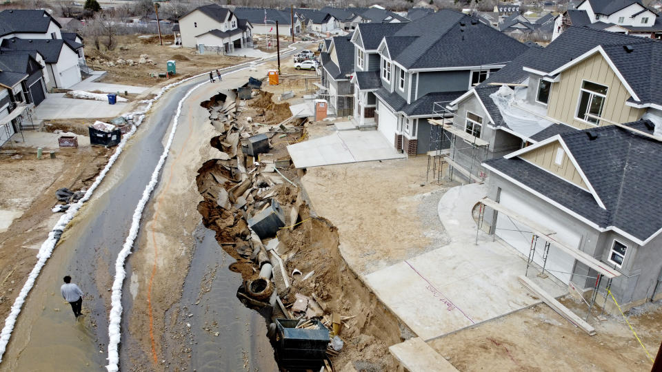 Local officials issued evacuation orders for at least 20 homes as temperatures spiked and snowmelt coursed through the streets on Wednesday, April 12, 2023, in Kaysville, Utah. A record-breaking snow season has raised fears of spring flooding throughout Utah as the weather in mountain regions warms. (AP Photo/Rick Bowmer)