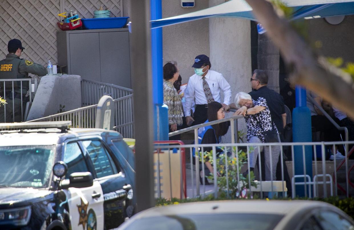 A first responder grief counselor comforts a parishioner after a person opened fire during a church service