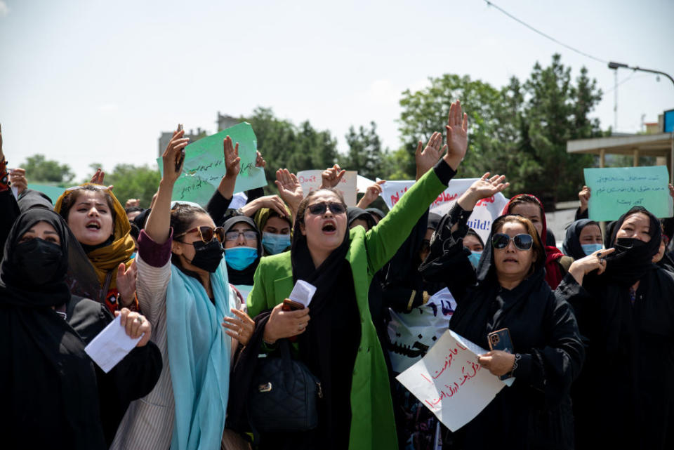 Taliban fighters fire into the air as they disperse a rare rally by women as they chant "Bread, work and freedom" and march in front of the education ministry building, days ahead of the first anniversary of the hardline Islamists' return to power, on August 13, 2022 in Kabul, Afghanistan.<span class="copyright">Nava Jamshidi/Getty Images</span>