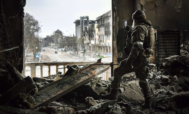 PHOTO: A Russian soldier patrols at the bombed out remains of Mariupol drama theatre in in Mariupol, Ukraine, April 12, 2022.  (Alexander Nemenov/AFP via Getty Images, FILE)