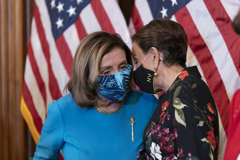 Speaker of the House Nancy Pelosi, D-Calif., pauses to hear from Rep. Nydia Velazquez, D-N.Y., as she discusses the upcoming vote on the American Dream and Promise Act of 2021, a bill to help reform the immigration system, at the Capitol in Washington, Thursday, March 18, 2021. (AP Photo/J. Scott Applewhite)