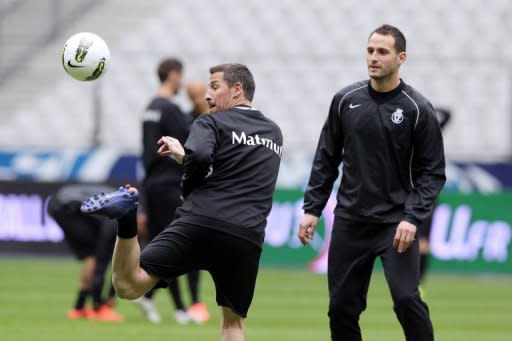 Quevilly's Pierrick Capelle (L) practices during a training session on April 27, at the Stade de France in Saint-Denis, northerm Paris, on the eve of their French Cup final mantch against Lyon