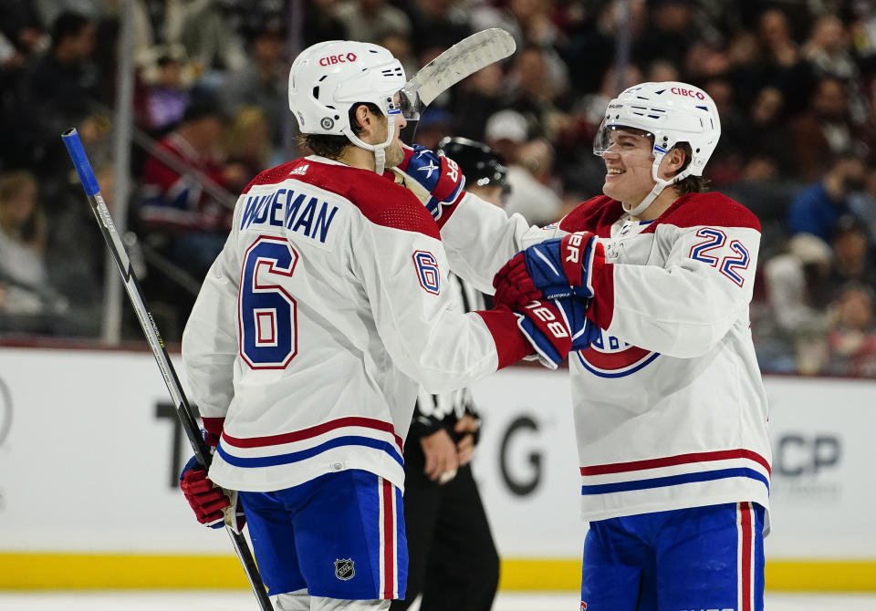 Montreal Canadiens' Chris Wideman (6) goes to celebrate Cole Caufield's (22) goal in the second period during an NHL hockey game against the Arizona Coyotes, Monday, Dec. 19, 2022, in Tempe, Ariz. (AP Photo/Darryl Webb)