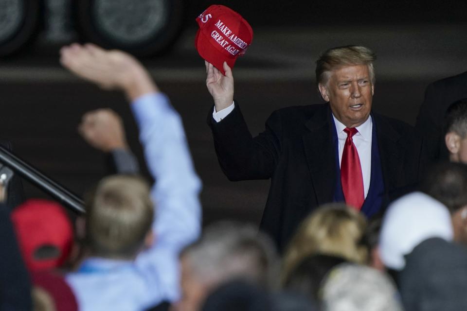 President Donald Trump throws a hat to the crowd after speaking at a campaign rally at the Central Wisconsin Airport Thursday, Sept. 17, 2020, in Mosinee, Wis. (AP Photo/Morry Gash)
