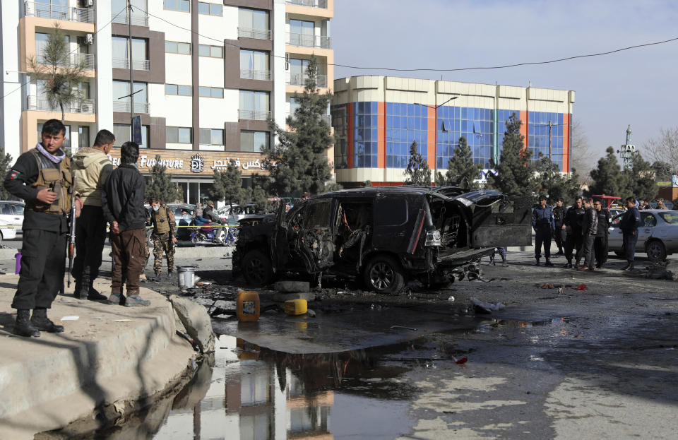 A destroyed vehicle sits at the site of a deadly bomb attack in Kabul, Afghanistan, Wednesday, Feb. 10, 2021. (AP Photo/Rahmat Gul)