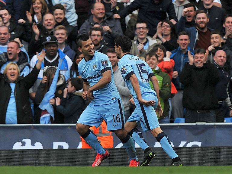 Manchester City striker Sergio Aguero (L) celebrates scoring their second goal against West Ham with Spanish teammate Jesus Navas (R) during the English Premier League match in Manchester, northwest England on April 19, 2015