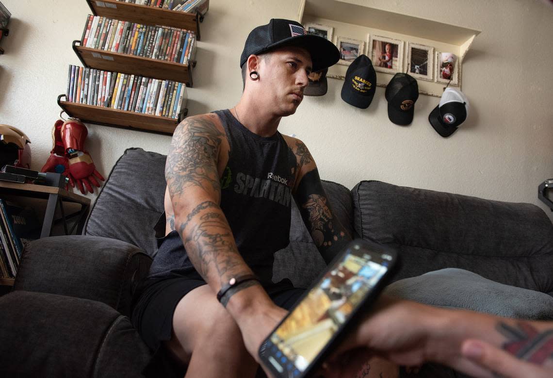 Casey Rich looks away from a cell phone video of him being stabbed at a McDonald’s restaurant in Ceres. The altercation with a DoorDash driver ended in him being stabbed 10 times. He is recovering in Ceres, Calif., on Thursday, August 4, 2022.