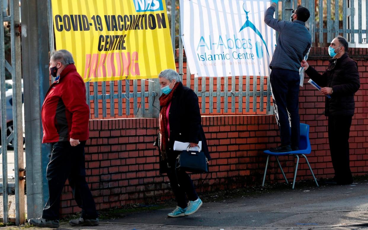 People queue for Covid vaccines at a vaccination centre in Birmingham. The Midlands has administered more doses than any other region - Darren Staples/AFP