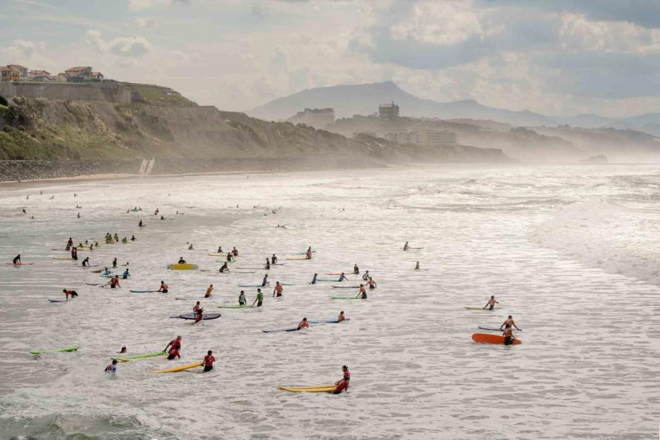 <p>Ambroise Tézenas</p> Surfers at Côte des Basques, a beach in Biarritz, France.