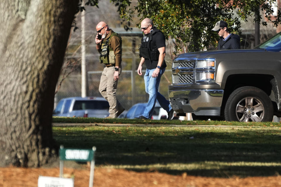 Lawmen patrol the grounds of the Mississippi State Capitol in Jackson, Miss., Thursday, Jan. 4, 2024, as they deal with a second consecutive day of bomb threats to the state house and to the Carroll Gartin Justice Building, which houses the state supreme and appellate courts. (AP Photo/Rogelio V. Solis)