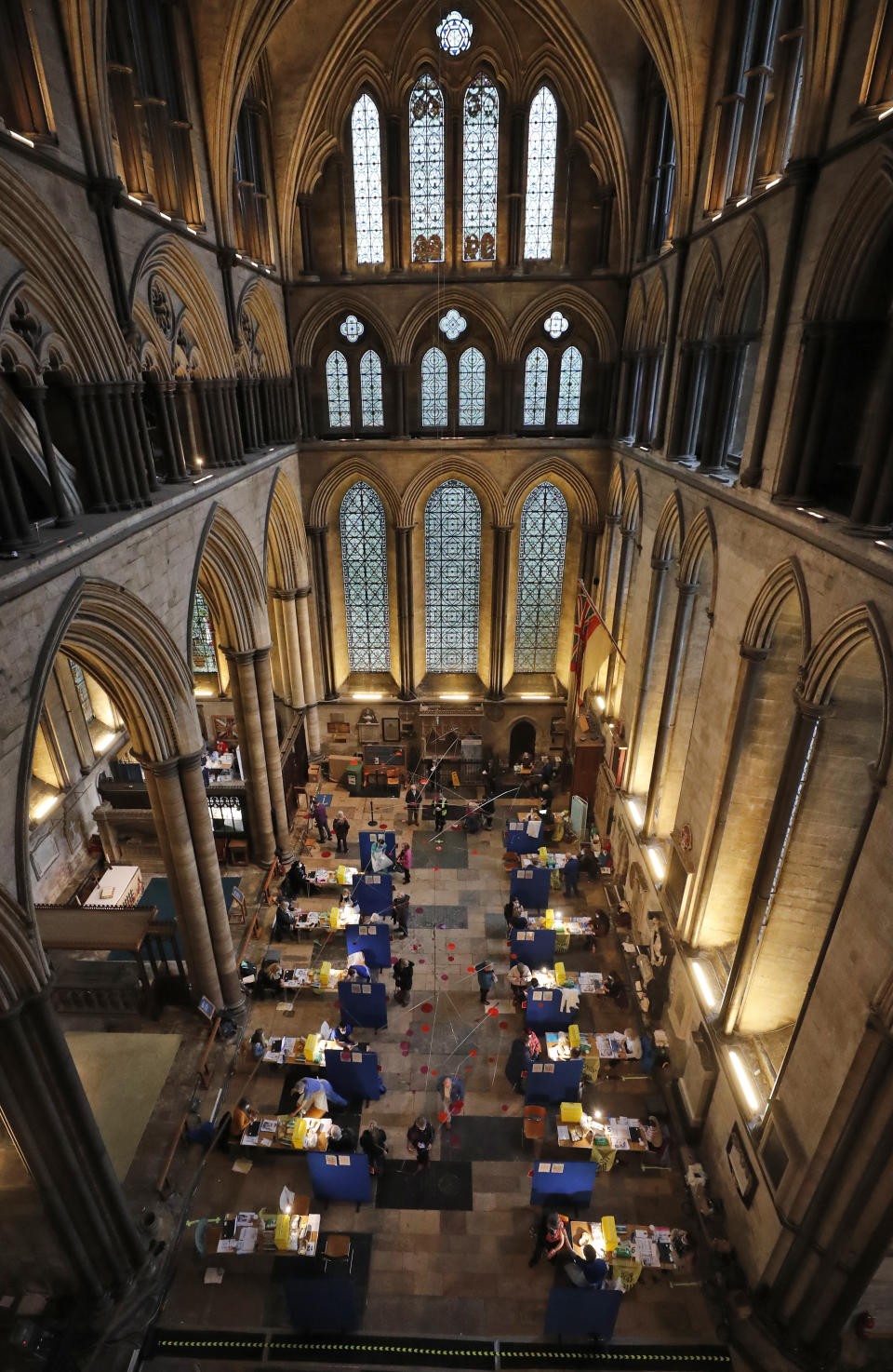 Fourteen tables are set up to provide the Pfizer-BioNTech vaccine inside Salisbury Cathedral in Salisbury, England, Wednesday, Jan. 20, 2021. Salisbury Cathedral opened its doors for the second time as a venue for the Sarum South Primary Care Network COVID-19 Local Vaccination Service. (AP Photo/Frank Augstein)