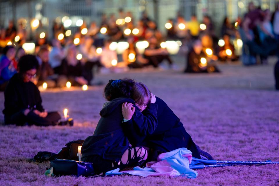 Eli Lynn hugs Milo Harrowa during a vigil on Sunday, Feb. 25, 2024, at Redbud Festival Park for Nex Benedict, the Owasso teen who died earlier in February, one day after they were hospitalized for injuries sustained in a school fight in Owasso, Okla.