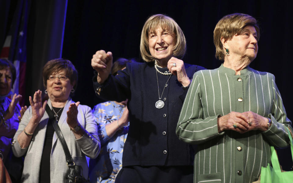 Holocaust survivors Lillian Feintuch, center, and Helen Kurtz, right, dance with other survivors on stage during a concert honoring their lives and celebrating the end of their pandemic isolation on Monday, June 14, 2021, at the Yeshivah of Flatbush theater at Joel Braverman High School in the Brooklyn borough of New York. (AP Photo/Jessie Wardarski)