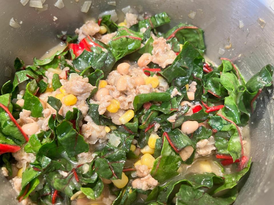 Swiss chard and chili flakes combined with ground-chicken chili in pot