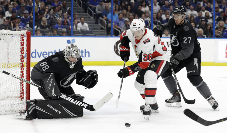Ottawa Senators left wing Rudolfs Balcers (38) picks up a rebound after Tampa Bay Lightning goaltender Andrei Vasilevskiy (88) made a save during the first period of an NHL hockey game Saturday, March 2, 2019, in Tampa, Fla. Defending for Tampa Bay is Ryan McDonagh (27). (AP Photo/Chris O'Meara)
