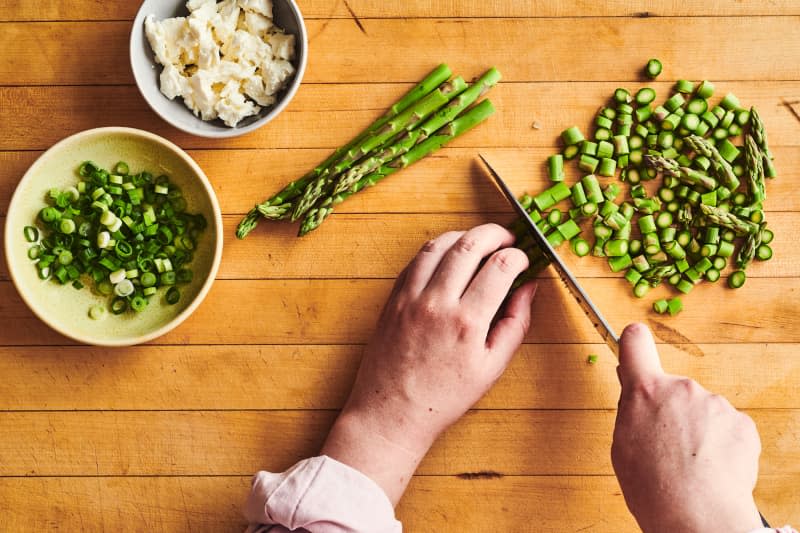 someone is chopping green vegetabkles