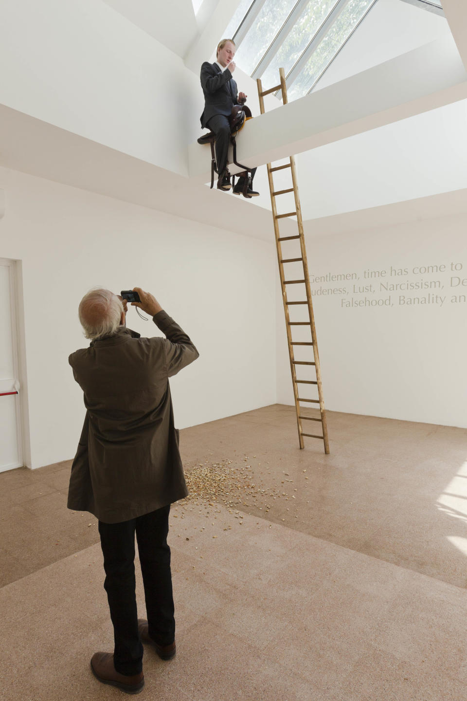 In this photo taken on Tuesday, May 28, 2013 a visitor photographs the installation 'Danae' by artist Vadim Zacharov in the Russian Pavilion during a press preview of the 55th edition of the Venice Biennale of Arts in Venice, northern Italy. (AP Photo/Domenico Stinellis)