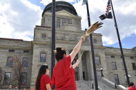 Women wear red to honor missing and murdered indigenous people during a ceremony in front of the Montana state Capitol in Helena, Mont., Wednesday, May 5, 2021. (AP Photo/Iris Samuels)