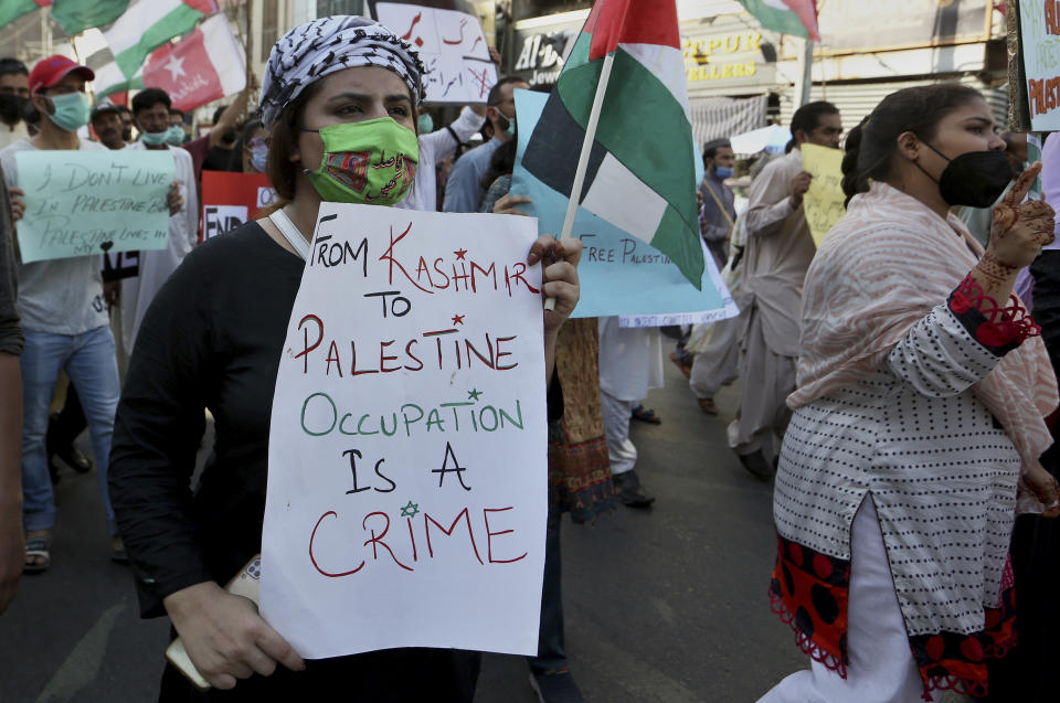 Woman displays a placard during a rally in support of Palestinians, in Karachi, Pakistan, Thursday, May 20, 2021. (AP Photo/Fareed Khan)