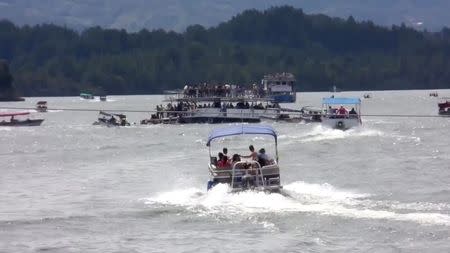 A ferry sinks in the Guatape reservoir near Medellin, Colombia June 25, 2017 in this still image taken from video obtained from social media. Louisa Murphy/via REUTERS