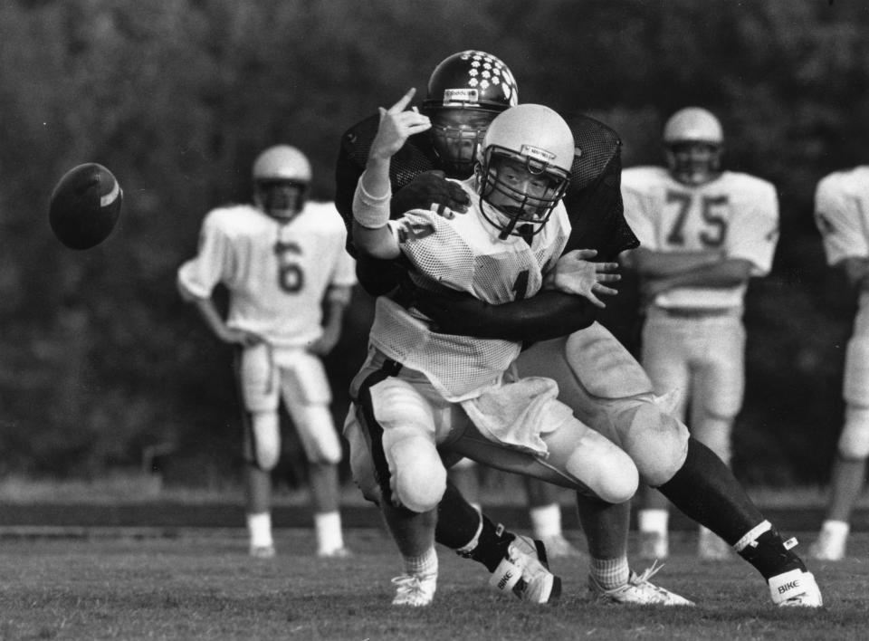 Rudy Stinson terrorizes Rockwood quarterback Brad Berry during a scrimmage at Powell on Aug. 16, 1991.