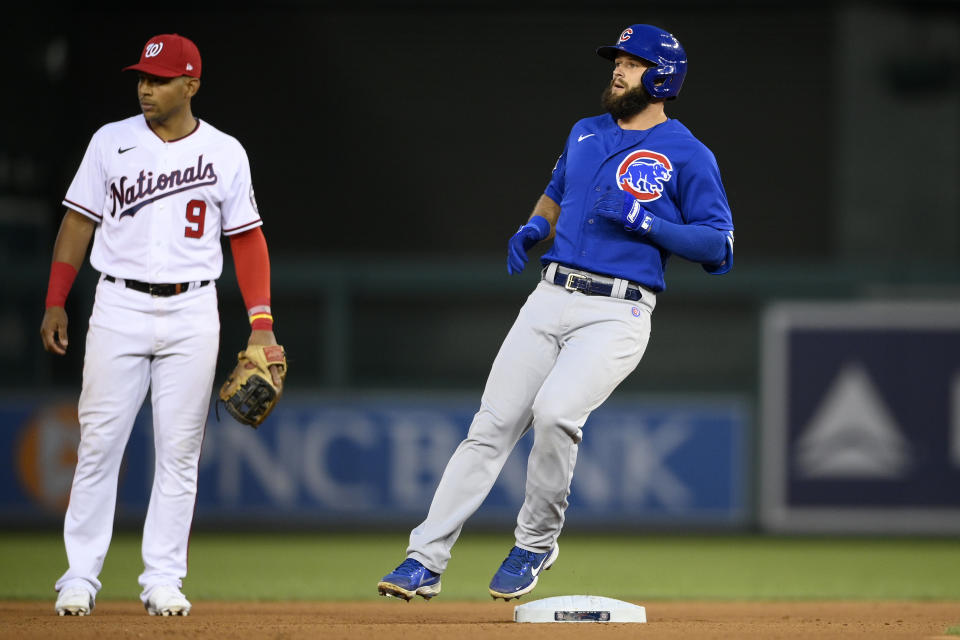 Chicago Cubs' David Bote, right, runs to second base with a double next to Washington Nationals shortstop Adrian Sanchez (9) during the fourth inning of a baseball game, Saturday, July 31, 2021, in Washington. (AP Photo/Nick Wass)