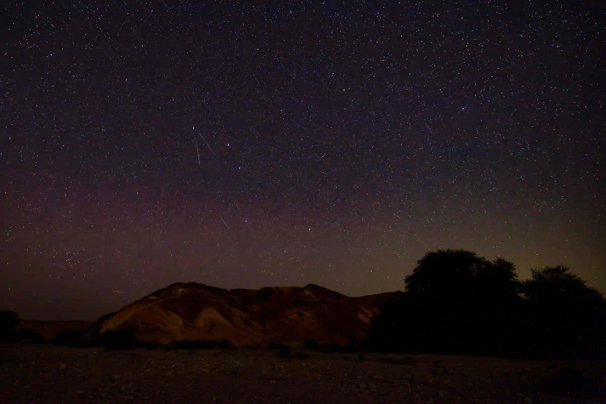 Perseid meteors streaks across the sky above a camping site in the southern israel Negev desert near the Israeli village of Faran early on 12 August 2023 (AFP via Getty Images)