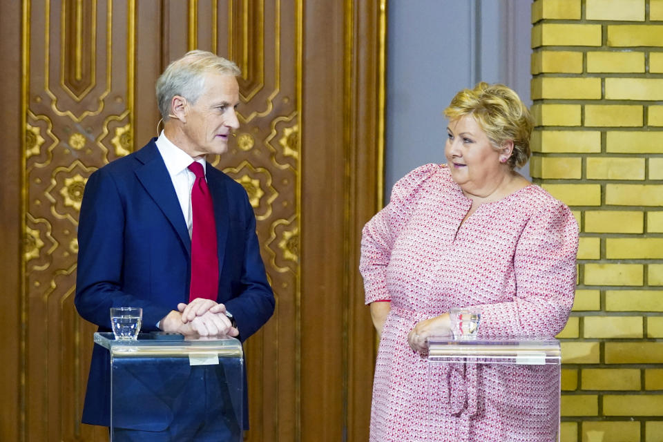 Jonas Gahr Store, left, and Erna Solberg speak during the party leader debate at the Storting during the municipal elections 2023, in Oslo, Norway, Monday, Sept. 11, 2023. (Lise Åserud/NTB Scanpix via AP)