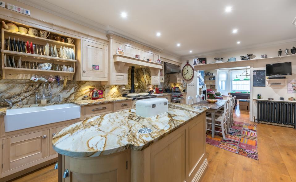 Though it boasts marble countertops and a marble backsplash, the kitchen, like the rest of the home, is quite eclectic.