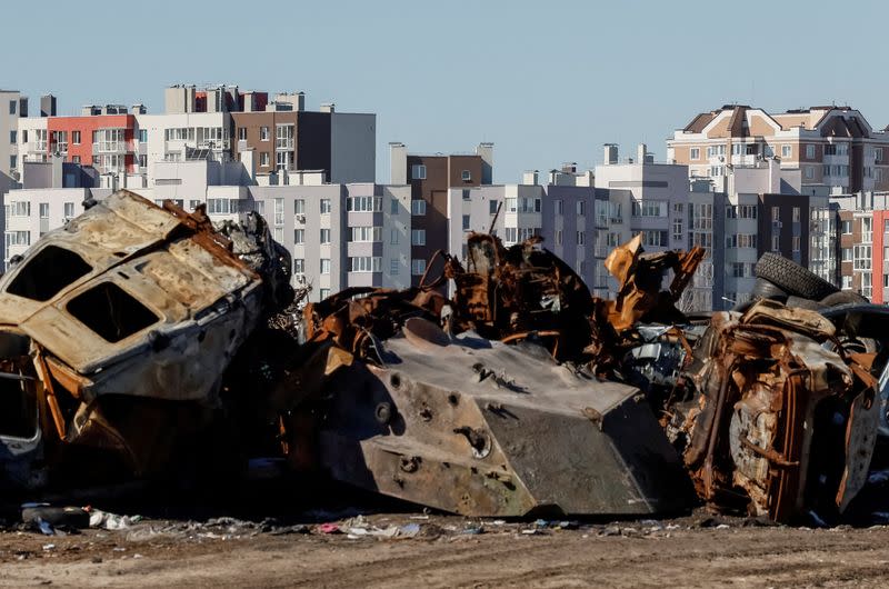 FILE PHOTO: Civilian cars and military vehicle destroyed amid Russia's attack on Ukraine, are seen in front of of apartment buildings in the town of Bucha