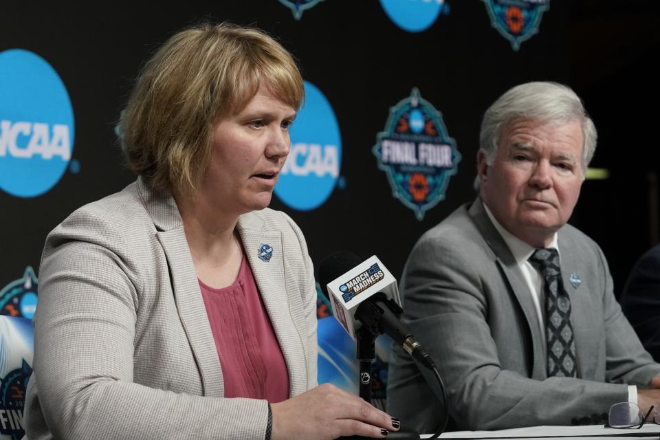 NCAA president Mark Emmert isstens as Vice President for Women's Basketball at NCAA Lynn Holzman speaks at a news conference at the Target Center, site of of the Women's Final Four NCAA tournament Wednesday, March 30, 2022, in Minneapoils. (AP Photo/Eric Gay)