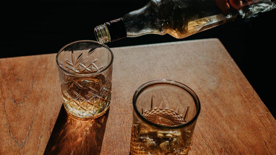 whisky pour from a bottle into a cut glass tumbler
