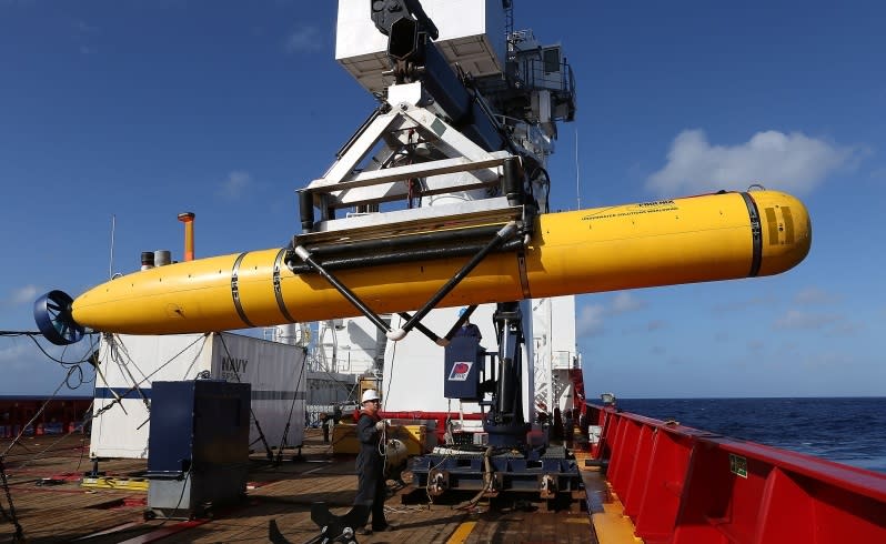 an autonomous underwater vehicle is craned over the side of the ocean shield in the search for missing malaysia airlines flight mh 370 . picture: adf