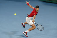 Novak Djovovic of Serbia plays a shot against Rafael Nadal of Spain during their ATP Cup tennis match in Sydney, Sunday, Jan. 12, 2020. (AP Photo/Steve Christo)