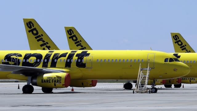 Spirit Airlines planes sit on the tarmac