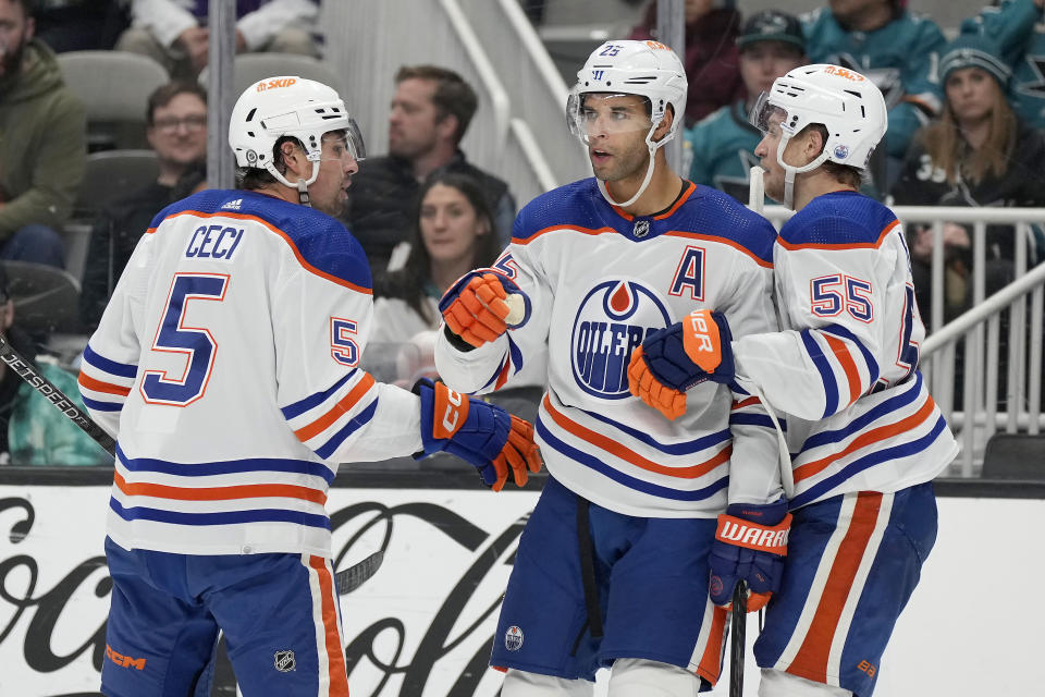 Edmonton Oilers defenseman Darnell Nurse, center, celebrates with Cody Ceci (5) and Dylan Holloway (55) after scoring a goal against the San Jose Sharks during the second period of an NHL hockey game Thursday, Nov. 9, 2023, in San Jose, Calif. (AP Photo/Tony Avelar)