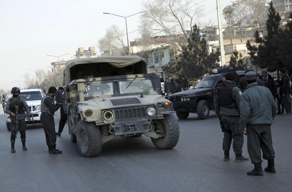 <p>Policemen block the road to the Intercontinental Hotel during a deadly attack in Kabul, Afghanistan, Jan. 21, 2018. (Photo: Massoud Hossaini/AP) </p>