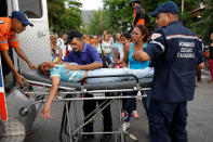 <p>Paramedics help a relative of inmates held at the General Command of the Carabobo Police, who fainted, outside the prison, where a fire occurred in the cells area, according to local media, in Valencia, Venezuela, March 28, 2018. (Photo: Carlos Garcia Rawlins/Reuters) </p>