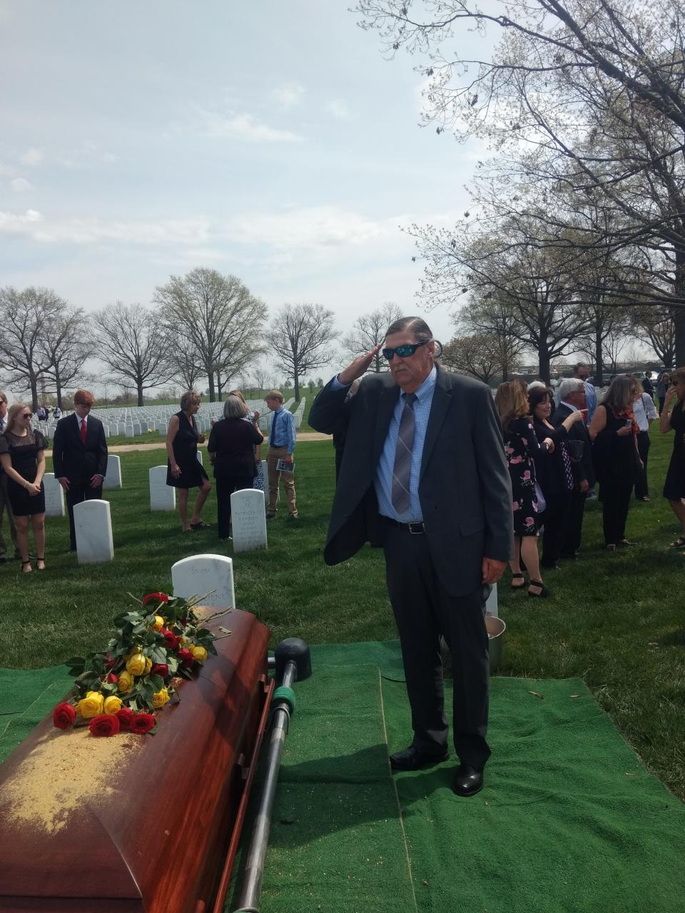 Jim Lynch salutes the casket of U.S. Air Force Col. Mayer Littman last month before it was lowered into a grave at Arlington National Cemetery.