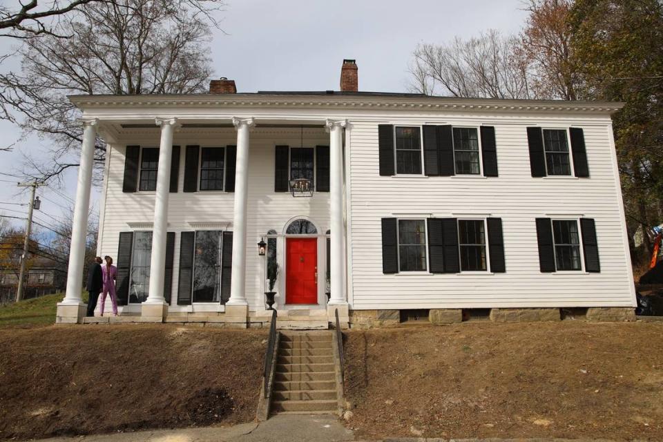 Robert Hartwell and his father, William, looking at the restored exterior of the home.