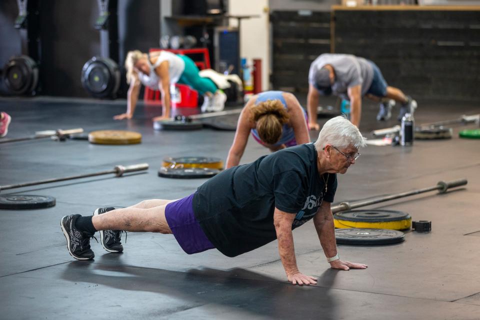 Mary Barraud of Brick holds a straight arm plank during a workout of the day class at JSA CrossFit in Manasquan, NJ Thursday, September 8, 2022.