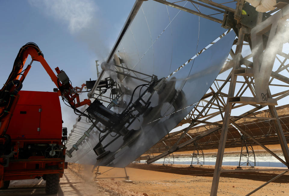 A machine cleans with water a row of parabolic shape mirrors, at the Shams 1, Concentrated Solar power (CSP) plant, in al-Gharibiyah district on the outskirts of Abu Dhabi. (Photo credit: MARWAN NAAMANI/AFP/Getty Images)